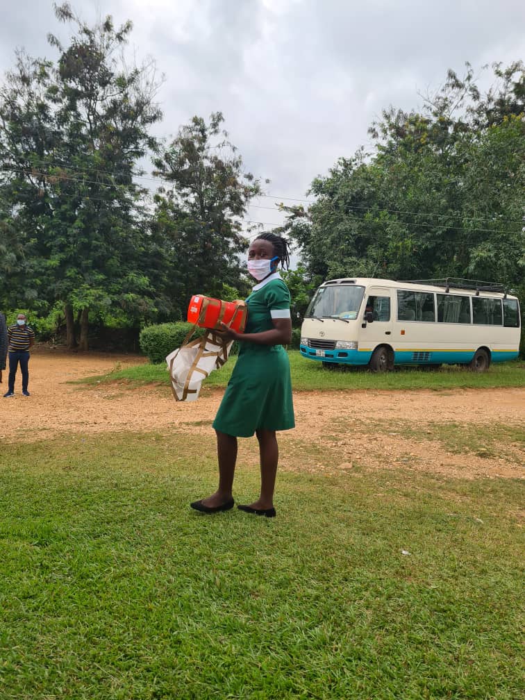 A healthcare worker at the Apedwa health center in Ghana picks up a box of medicines dropped seconds ago by a drone